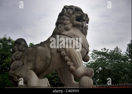 Male lion guard holding a ball in China Stock Photo