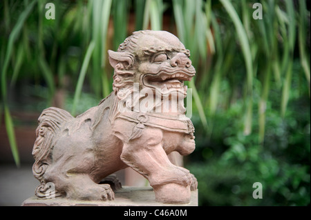 Male lion guard holding a ball in China Stock Photo