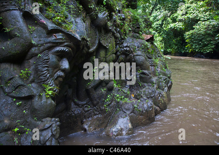 Artisans have carved the story of the RAMAYANA in stone along the banks of the AYUNG RIVER - UBUD, BALI, INDONESIA Stock Photo