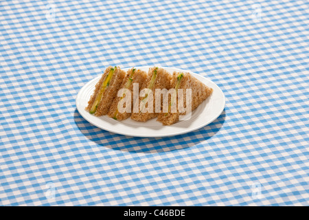 Cucumber sandwich on a check tablecloth. Stock Photo