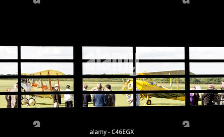 A view from a hangar of a Tiger Moth and a BE2 vintage aircraft at Sywell Aerodrome Stock Photo