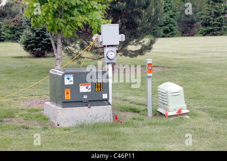 Electric utility transformer and temporary meter at construction site Stock Photo