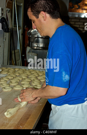 Baker hand rolling bagels at Saint-Viateur bagel bakery Plateau district Montreal Quebec Stock Photo