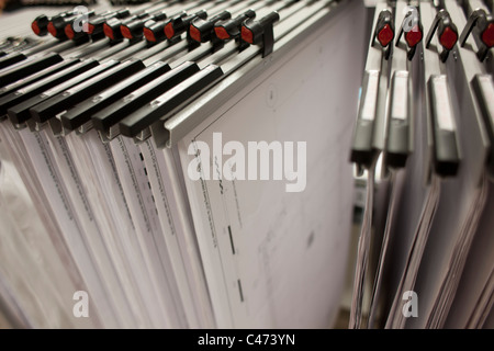 architectural plans hanging in a rack Stock Photo