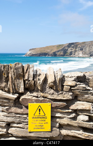 Warning sign at a cliff edge in Cornwall, UK Stock Photo