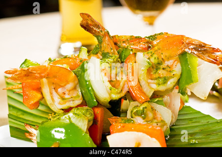 fresh and colorfull grilled shrimps and vegetables skewers on a palm leaf ,thai style Stock Photo