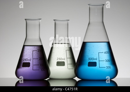 group of three conical flasks containing liquid shiny Stock Photo