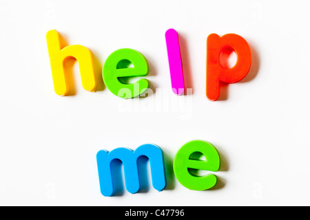 Magnetic letters on a fridge door spelling out 'Help Me' Stock Photo