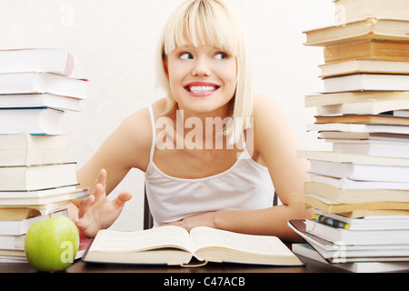 Young student woman with lots of books studying for exams. isolated on white background Stock Photo