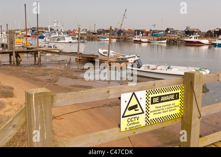 Warning sign about cctv cameras near boats at Walberswick in Suffolk , England , Britain , Uk Stock Photo