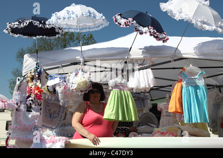 A stall selling baby clothes at the Appleby Horse Fair, Appleby-In-Westmorland, Cumbria, England, U.K. Stock Photo