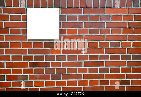 Empty board on the wall of red bricks Stock Photo