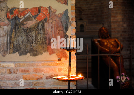 A frescoe fragment and sculpture of Jesus in Chiesa Martyrium inside the Basilica di Santo Stefano of Bologna Stock Photo