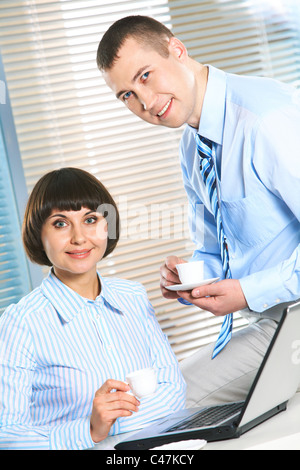 Photo of smart businessman and secretary looking at camera during tea break Stock Photo