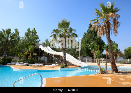 swimming pool with slides on holiday in tropical environment Stock Photo