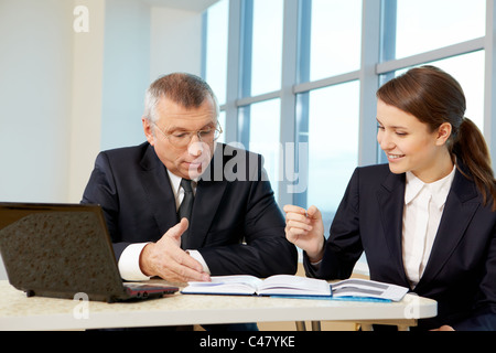 Boss and secretary planning work in office Stock Photo