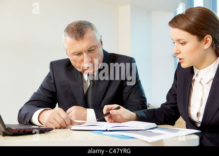 Boss and secretary planning work in office Stock Photo