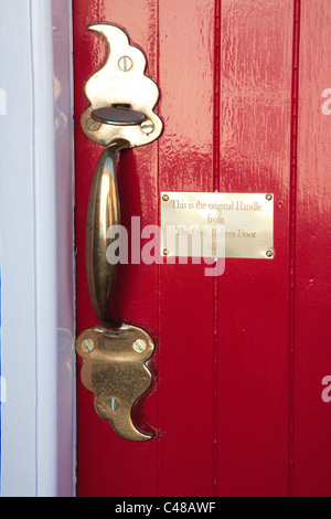 Red door with brass plaque Kinsale County Cork Ireland Stock Photo