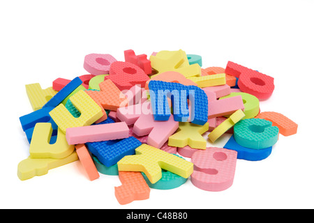 Pile of foam letters on white background. Stock Photo
