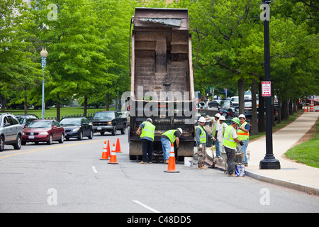 Road crew repairing a road in Washington DC Stock Photo