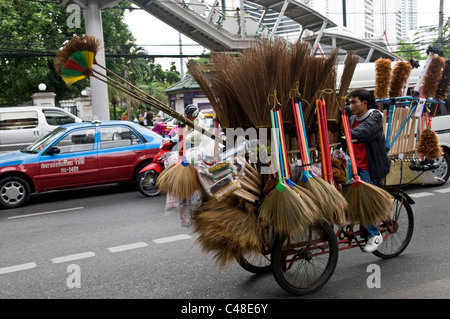 Traffic in Bangkok. The broom seller stuck on Sukhumit road. Stock Photo