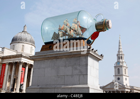 Ship in a bottle on the fourth plinth in Trafalgar Square, the National Gallery and St. Martin's in the Fields Church in London Stock Photo