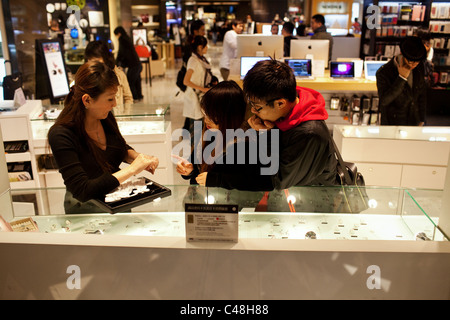 A young couple shops for rings at a mall in Taipei, Taiwan, October 29, 2010. Stock Photo