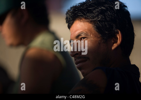 A Central American migrant traveling across Mexico to work in the United States stands at a shelter in Ixtepec, Oaxaca, Mexico Stock Photo