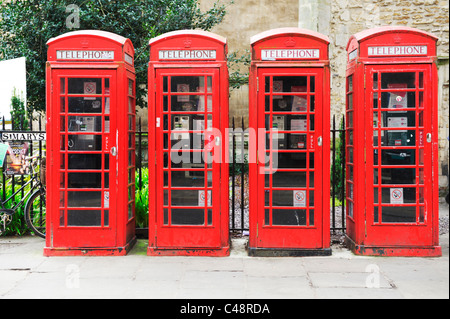 Four red British telecom telephone boxes in a street in the university town of Cambridge in England Stock Photo