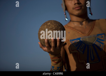 A Mayan ball player holds up the ball made of hule in Chapab village in Yucatan state in Mexico's Yucatan peninsula Stock Photo