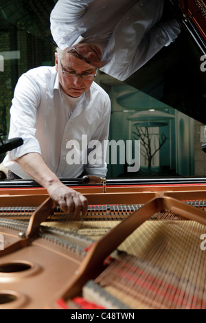 Man according a piano Stock Photo