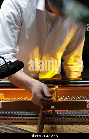 Man according a piano Stock Photo