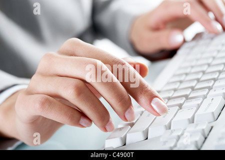 Macro image of human hand with forefinger going to press key on keyboard Stock Photo