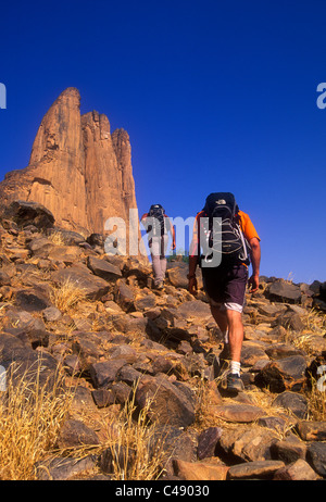 Two men hike to the Hand of Fatima, Mali, West Africa. Stock Photo