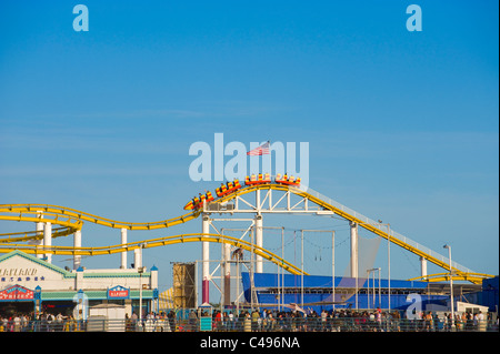 People riding roller coaster at Santa Monica Pier Stock Photo