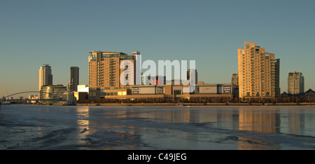 Salford Quays Frozen water looking towards the Lowry Centre and Media City . Stock Photo