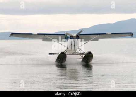 Cessna 182 float plane landing on Becharof Lake Alaska Stock Photo