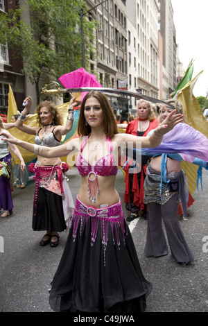 Anuual New York City Dance Parade along Broadway in New York City.  Belly dancers balance swords on their heads as they dance. Stock Photo