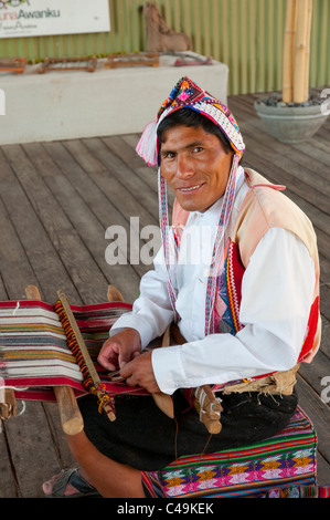 A Peruvian man demonstrating alpaca wool weaving in a store in Arequipa, Peru. Stock Photo