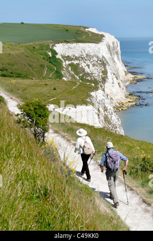 View from above looking down on couple walking cliff footpath on the Langdon Cliffs above the White Cliffs of Dover beside the English Channel Kent UK Stock Photo