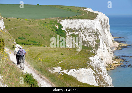 View from above looking down on couple walking cliff footpath on Langdon Cliffs landscape above White Cliffs of Dover beside English Channel Kent UK Stock Photo