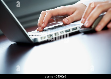 Image of human hands pressing keys of laptop Stock Photo