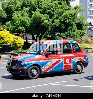 Street scene side view black Taxi cab temporary covered Vodafone London Calling Union Jack flag & text tag word cloud advertising graphic England UK