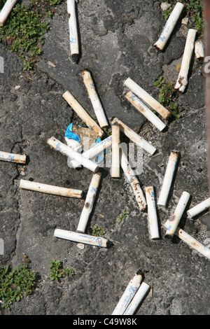 lots of cigarettes stubs on floor ground Stock Photo