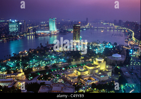 Egypt, Cairo, City by Nile river with Opera House in foreground at dusk Stock Photo