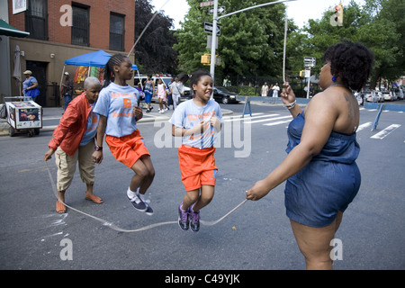 Practicing Double Dutch (jump rope) on the street in Brooklyn during the Dance Africa Festival at BAM Brooklyn Academy of Music Stock Photo