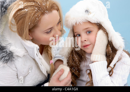 Portrait of mother and her daughter in warm winter clothes Stock Photo