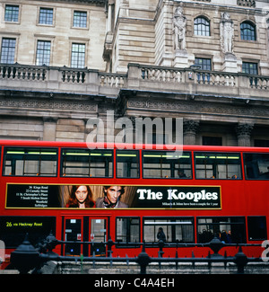 French fashion brand The Kooples advertising on the side of a red London bus in front of the Bank of England, London UK Stock Photo