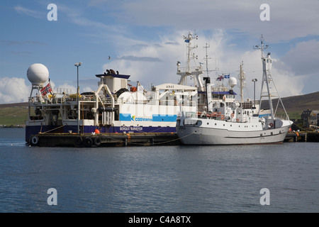 Lerwick Shetland Islands Scotland UK Bergen Surveyor a dredger moored in the harbour alongside fishing vessel Juvel 11main Shetland Island Stock Photo