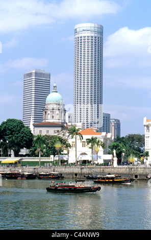 Singapore. Bum boat with tourists sails past colonial and modern buildings on Singaprore river. © Bob Kreisel Stock Photo